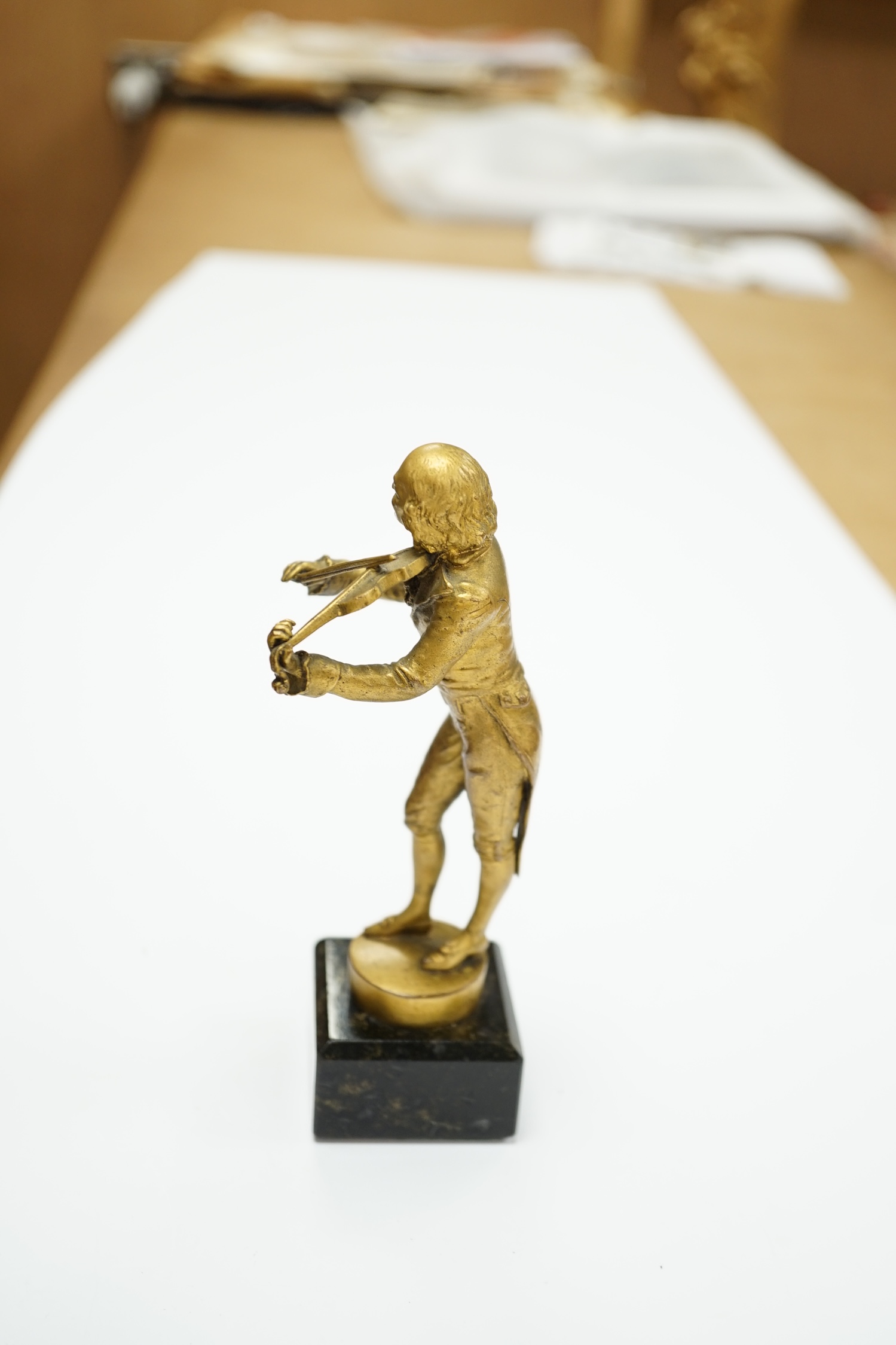 An ormolu bronze of a violinist on a marble base, signed Aktien-Gesellschaft Gladenbeck, Berlin, 14cm high